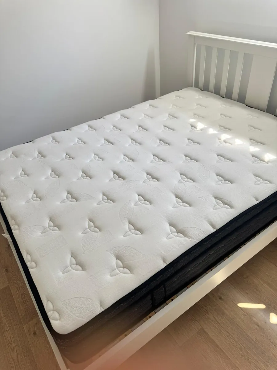 Freshly cleaned mattress on a white bed frame looking bright and sanitised